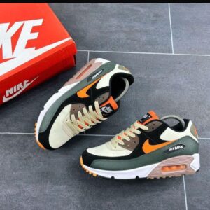 A pair of Nike Air Max shoes in black, orange, and green, with a matching shoe box, perfect for active lifestyles and fashion enthusiasts.