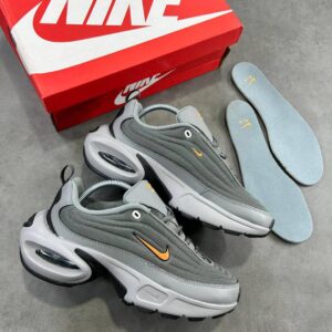 Grey and orange Nike Air Max 270 React shoes with box and insoles on a grey background.