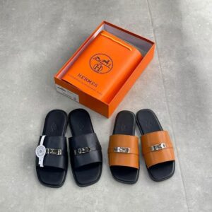 High-quality image of Hermes luxury slide sandals in black and brown, complete with an orange box and bag.