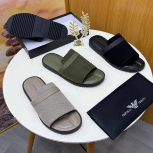 A pair of luxurious olive green Armani slide sandals on a white surface, exuding high-end style and comfort, perfect for the elite in Nigeria.