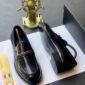A pair of luxurious black leather loafers displayed on a white paper with a shoe horn and a decorative ship's wheel in the background, symbolizing high-end fashion and sophistication.