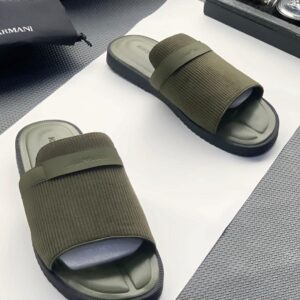 A pair of luxurious olive green Armani slide sandals on a white surface, exuding high-end style and comfort, perfect for the elite in Nigeria.
