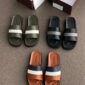 A collection of luxury Pedro brand slide sandals in various colors, including green, black, and brown, displayed on a carpeted floor with shoe boxes and a bottle in the background.