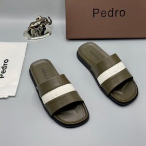 Luxury Pedro slides with brown, navy blue, and white straps, presented with a brown box and silver elephant figurine on a grey background | Levonteluxe