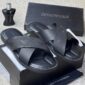 A pair of luxurious black Emporio Armani slides in their box, exuding opulence and refinement.